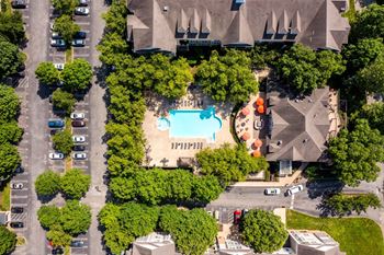 An aerial view of a parking lot with a swimming pool and trees.at Riverview Landing @ Valley Forge, Eagleville, PA 19403
